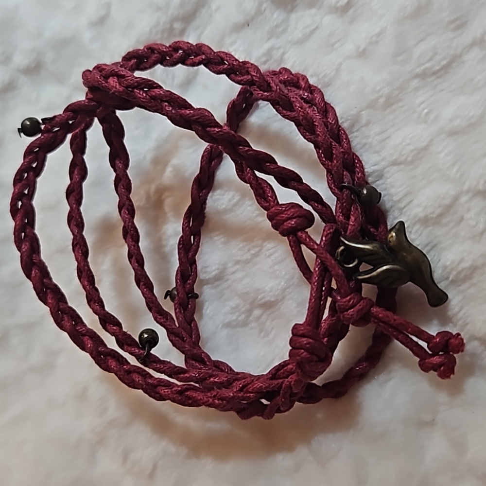 Dark red braided bracelet with gold bird